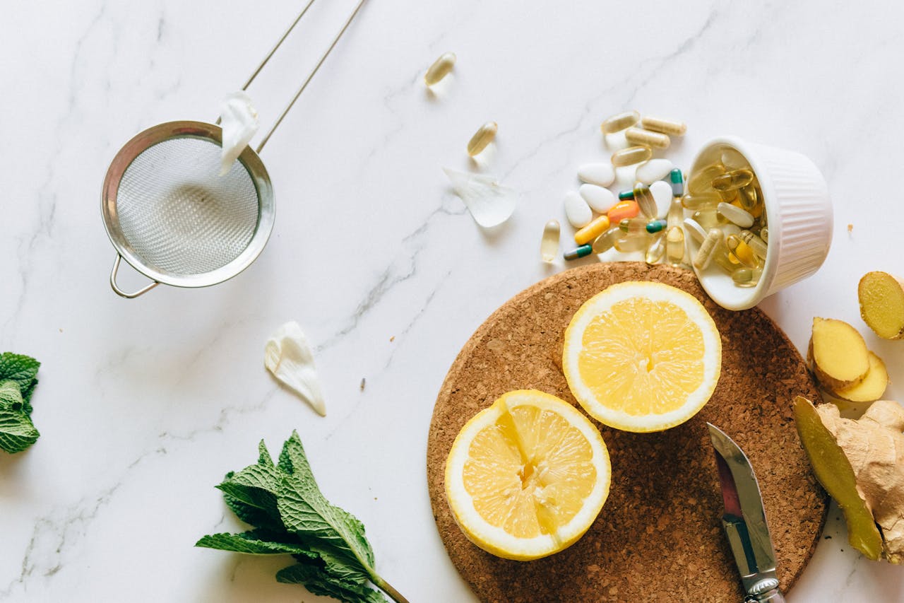 About Flat lay of lemon, ginger, and supplements on a marble surface, illustrating natural remedies.